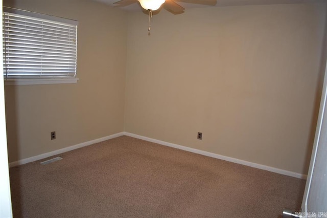 spare room featuring carpet flooring and ceiling fan