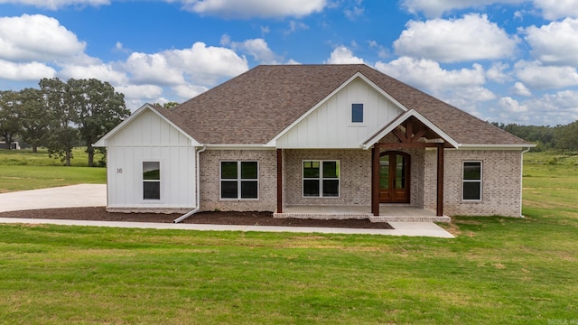 view of front of home with a front yard and french doors