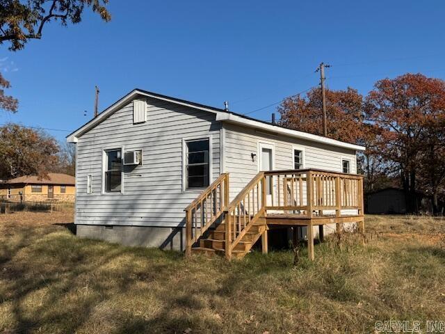 rear view of property with a yard and a deck