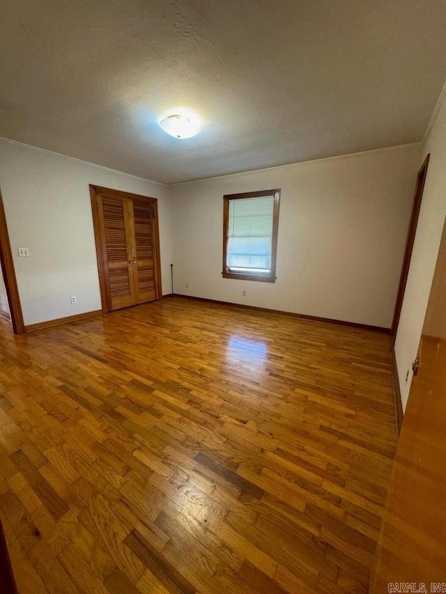 unfurnished bedroom with a textured ceiling and hardwood / wood-style flooring