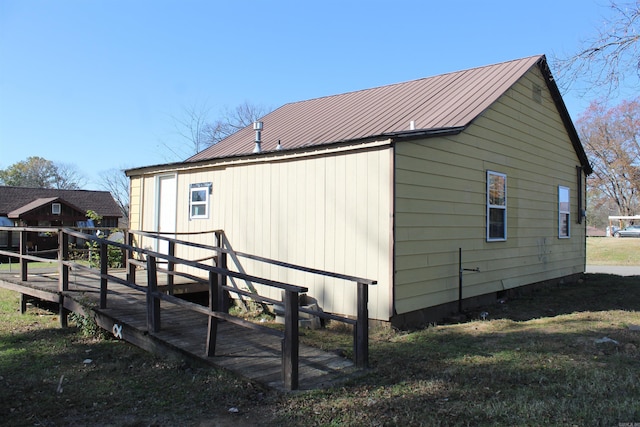 view of property exterior featuring a deck and a lawn