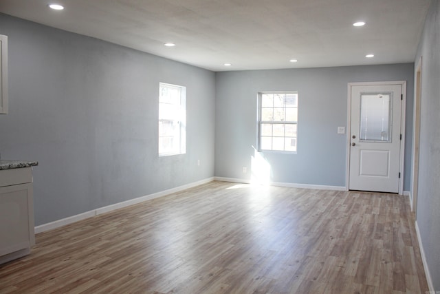 spare room featuring light hardwood / wood-style flooring