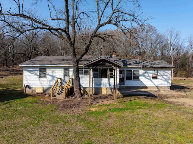 view of front of house featuring a front yard and a patio area