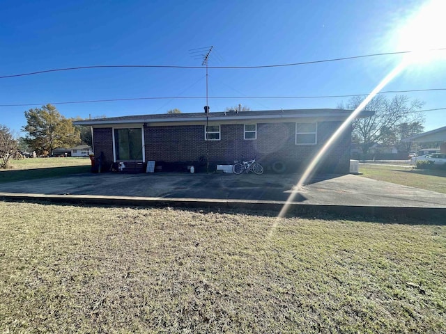 back of property featuring a wooden deck and a yard