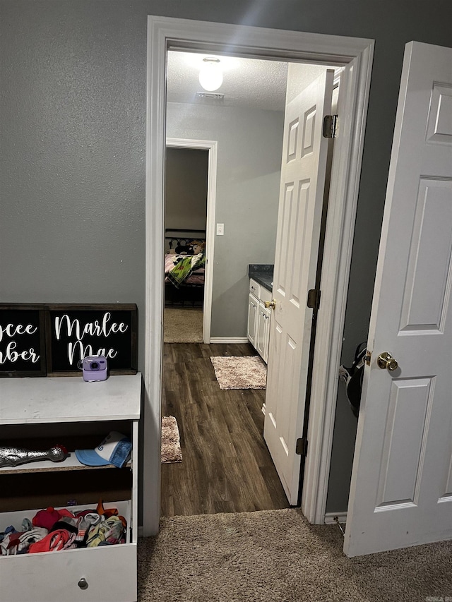 hallway with dark hardwood / wood-style flooring