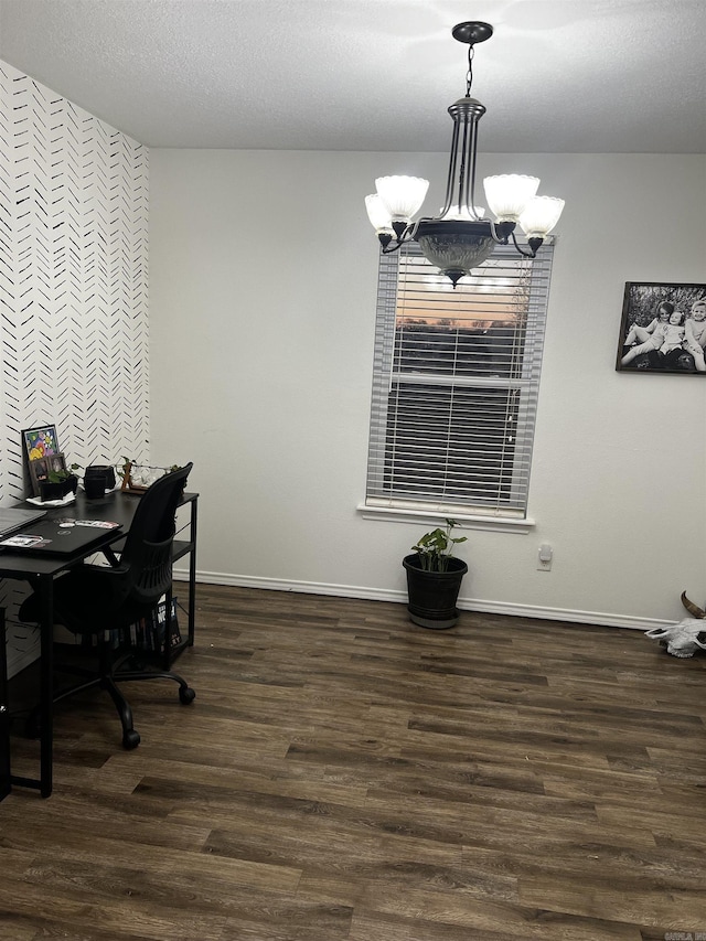 dining room with dark hardwood / wood-style flooring, a textured ceiling, and an inviting chandelier