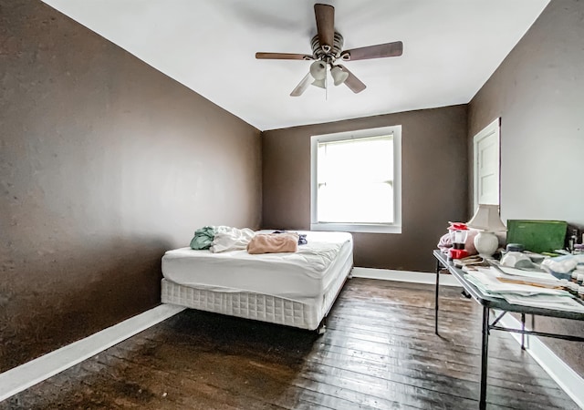 bedroom with ceiling fan and dark wood-type flooring