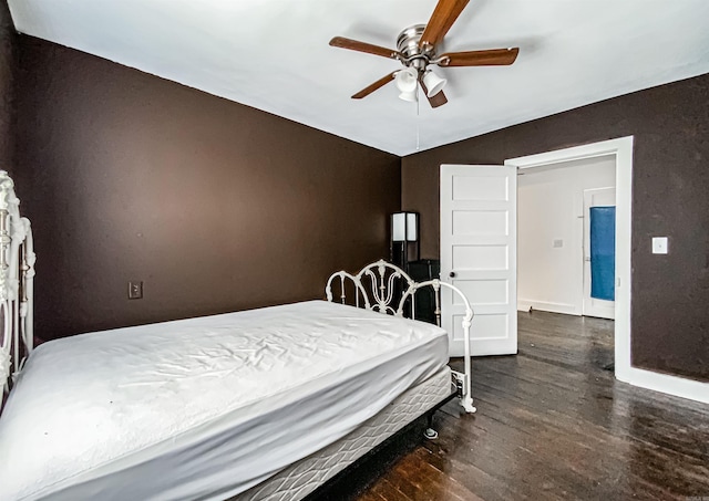 bedroom with ceiling fan and dark hardwood / wood-style flooring