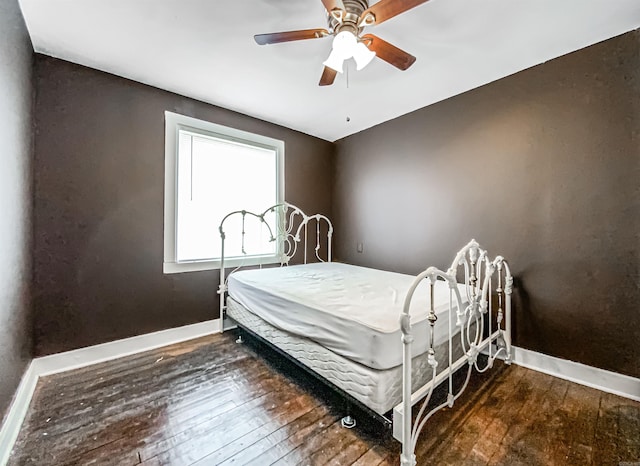 bedroom with ceiling fan and dark hardwood / wood-style floors