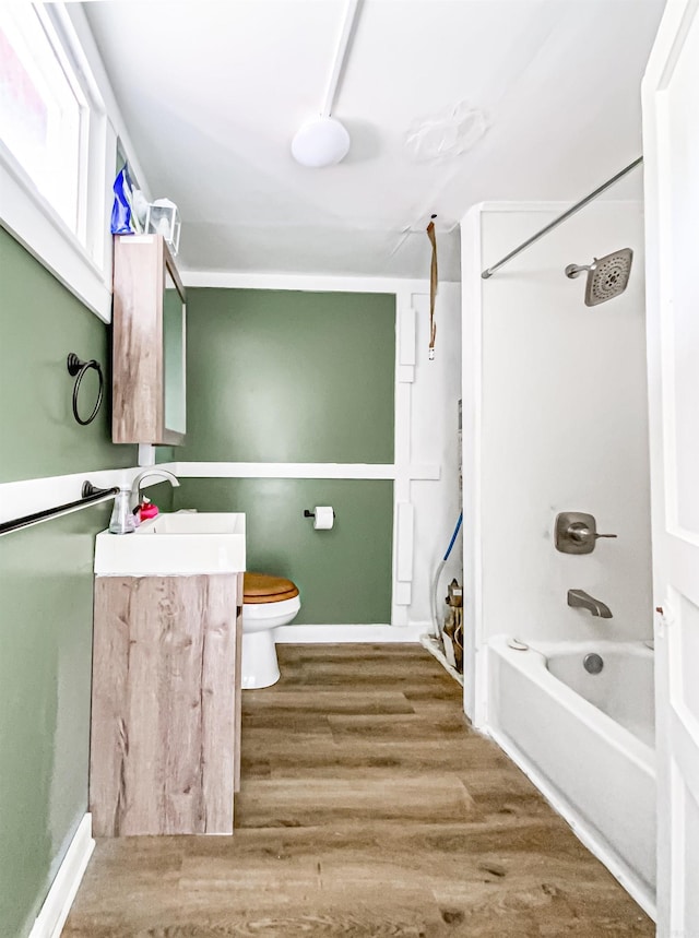 full bathroom with vanity,  shower combination, toilet, and wood-type flooring