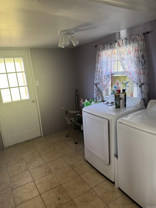 washroom featuring separate washer and dryer and light tile patterned floors