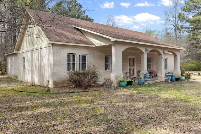 exterior space featuring a porch and a front yard