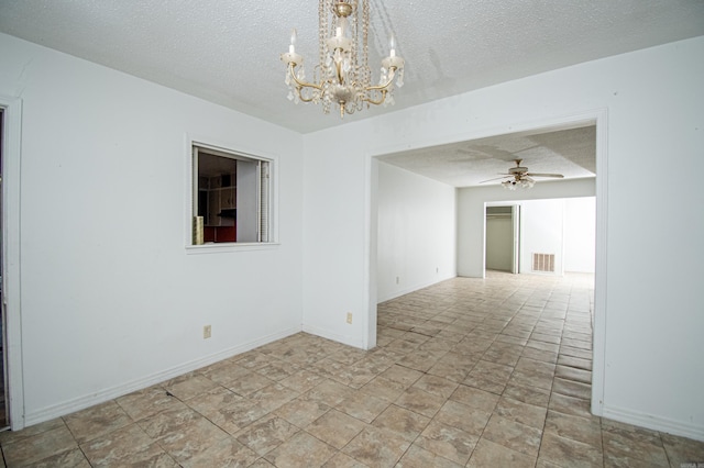 unfurnished room with a textured ceiling and ceiling fan with notable chandelier