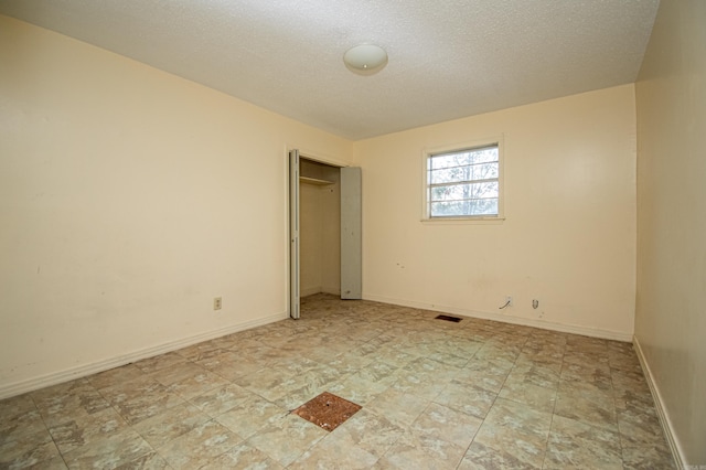 unfurnished bedroom with a textured ceiling