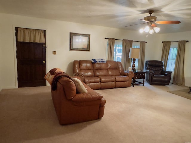 carpeted living room featuring ceiling fan and a wealth of natural light