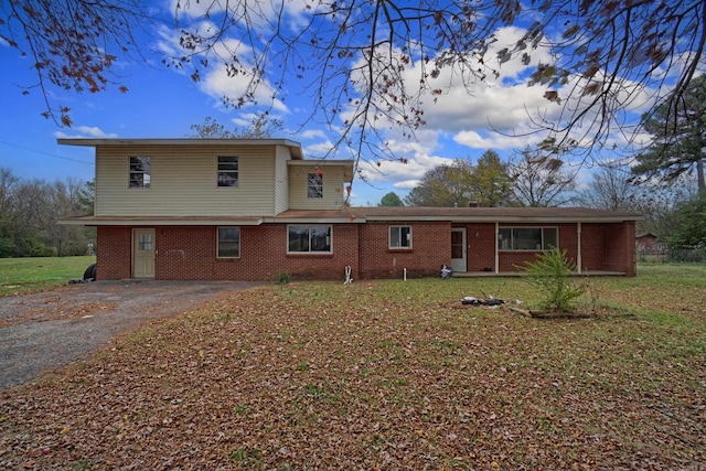 rear view of house with a yard