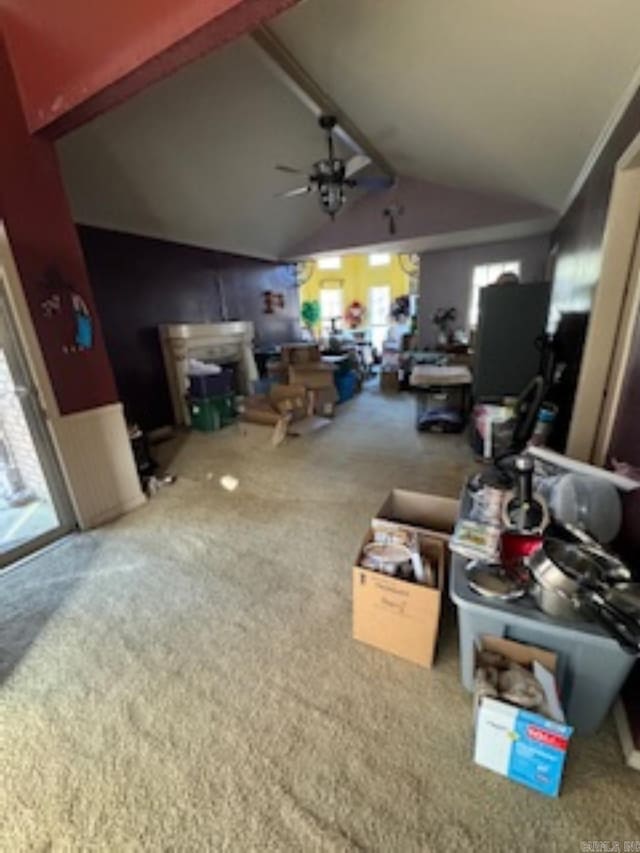 living room featuring carpet flooring, ceiling fan, and vaulted ceiling