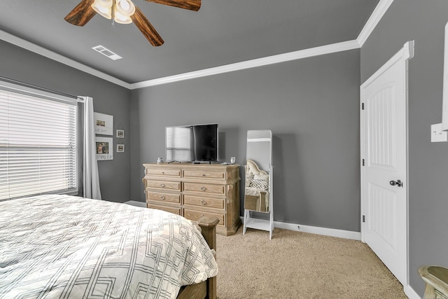 bedroom featuring multiple windows, ceiling fan, crown molding, and light carpet