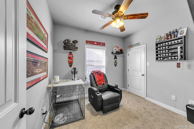 sitting room featuring carpet floors and ceiling fan