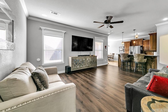 living room with dark hardwood / wood-style floors, ceiling fan, and crown molding