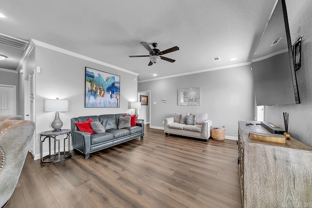 living room featuring dark hardwood / wood-style flooring, ceiling fan, and crown molding