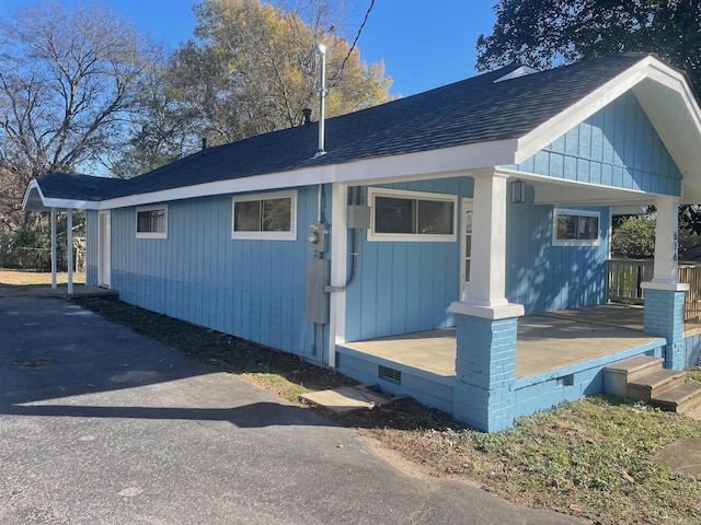 view of side of home featuring a porch