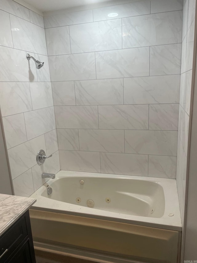 bathroom with vanity and tiled shower / bath