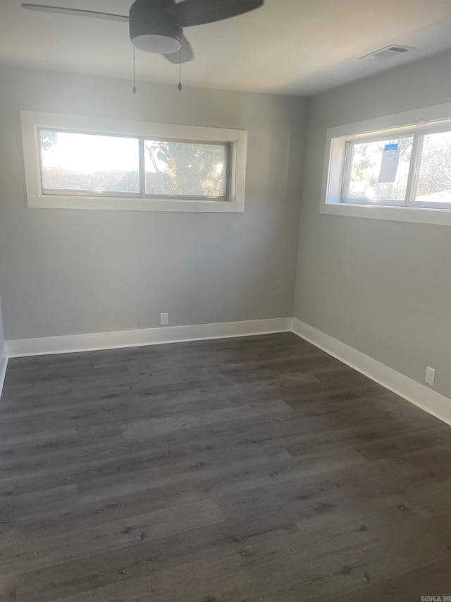 empty room featuring ceiling fan and dark hardwood / wood-style flooring