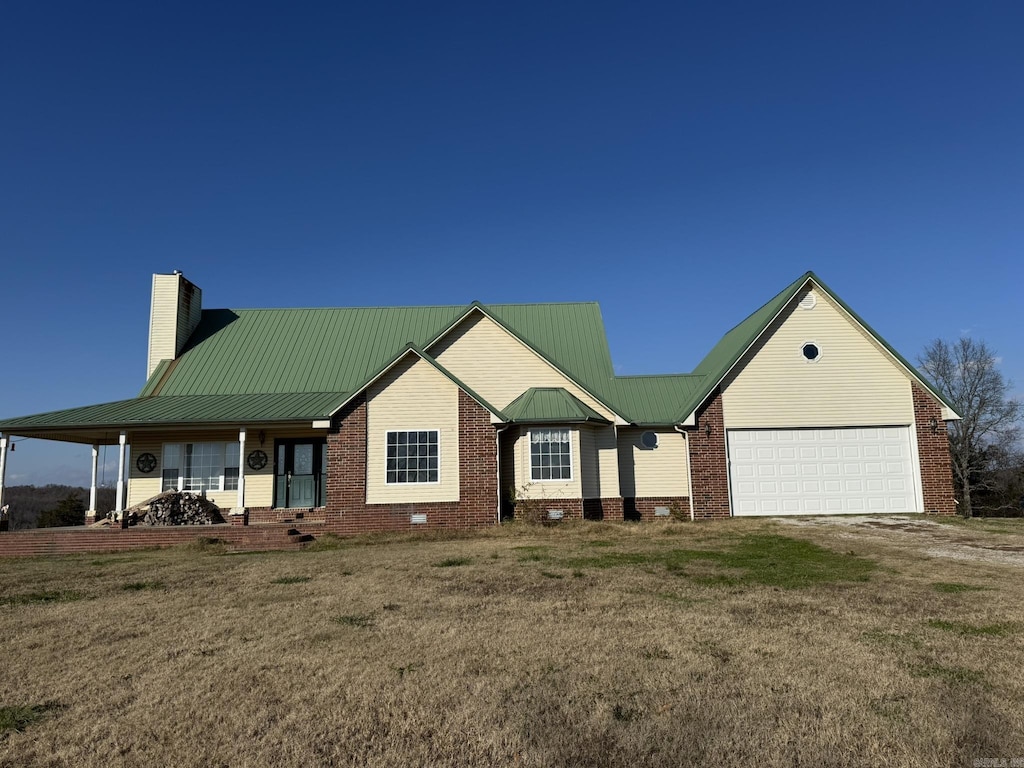 view of front facade with a porch, a garage, and a front yard