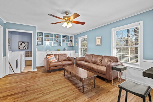 living room featuring a textured ceiling, light hardwood / wood-style floors, ceiling fan, and ornamental molding