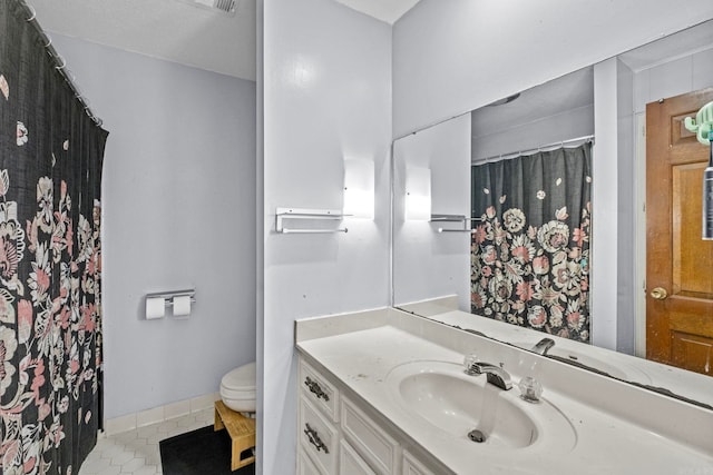 bathroom with tile patterned floors, vanity, and toilet