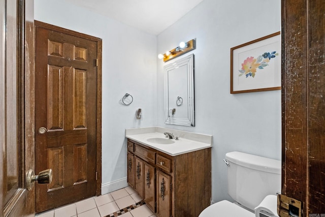 bathroom featuring tile patterned flooring, vanity, and toilet