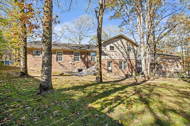 rear view of house with a yard