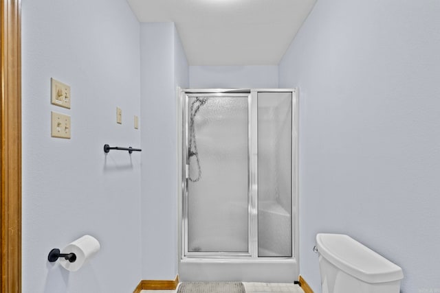 bathroom with an enclosed shower and toilet