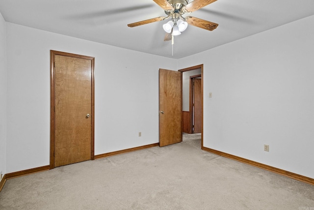 spare room with light carpet and ceiling fan