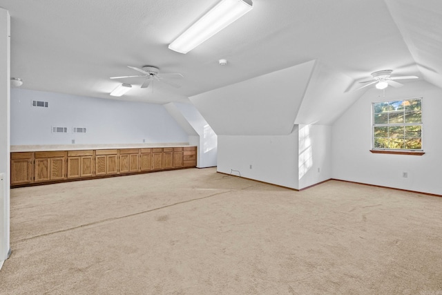 bonus room with ceiling fan, lofted ceiling, and light carpet