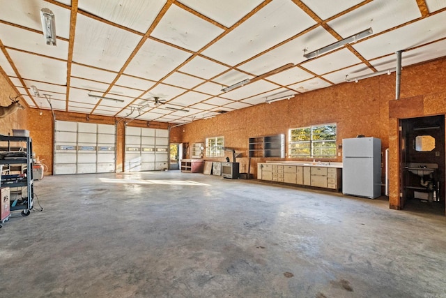 garage featuring white fridge and sink