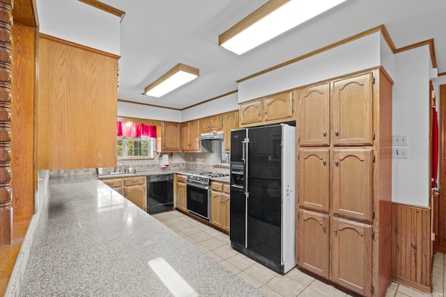 kitchen with decorative backsplash, wooden walls, sink, crown molding, and black appliances