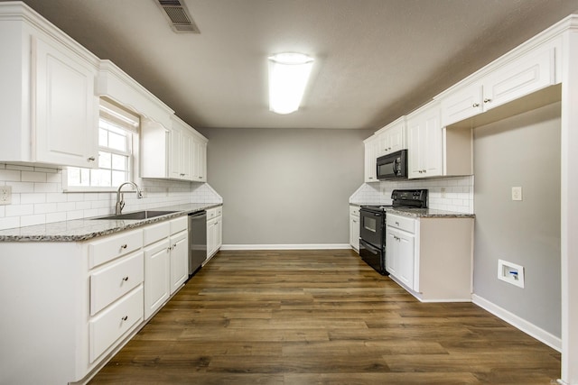 kitchen with white cabinets, light stone counters, and black appliances