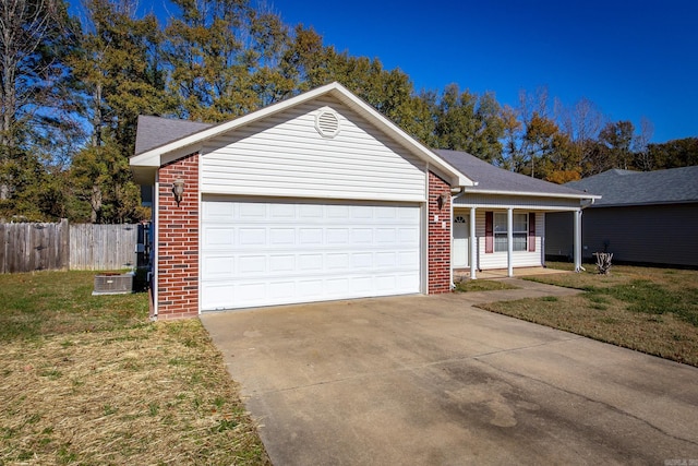 ranch-style home with a front lawn, a porch, and a garage