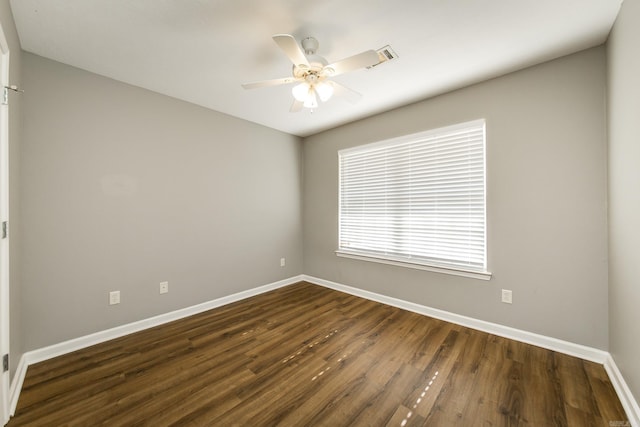 spare room featuring ceiling fan and dark wood-type flooring