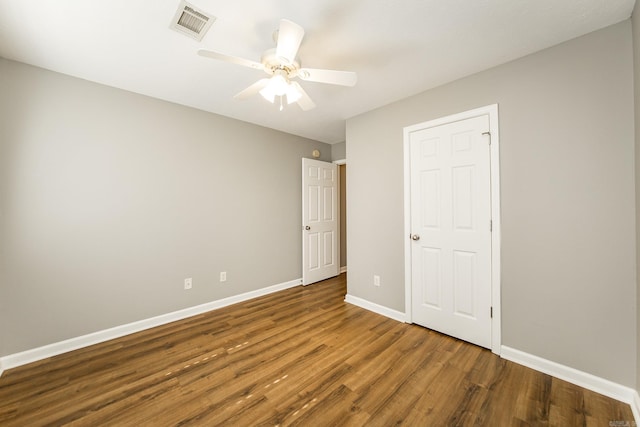 unfurnished bedroom featuring ceiling fan and hardwood / wood-style flooring