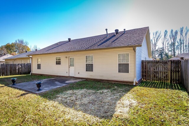 rear view of property with a patio and a lawn