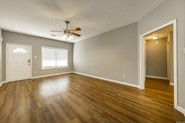 interior space with ceiling fan and dark wood-type flooring