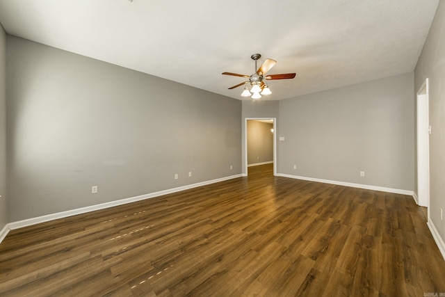 spare room with ceiling fan and dark hardwood / wood-style flooring