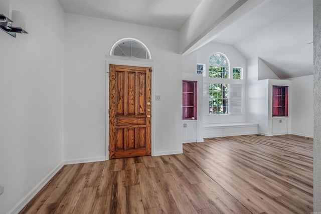 foyer entrance featuring light hardwood / wood-style floors and vaulted ceiling