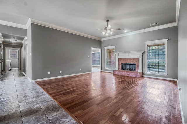 unfurnished living room with crown molding, a fireplace, ceiling fan, and wood-type flooring