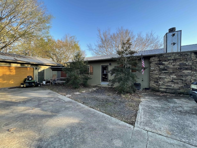 rear view of property with a garage