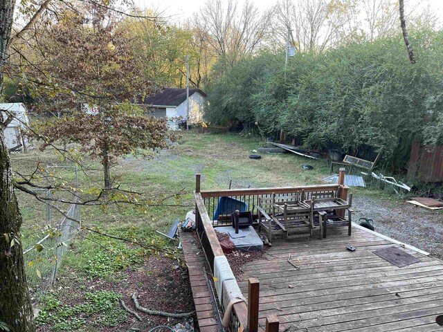 deck featuring an outbuilding, a yard, and an outdoor hangout area
