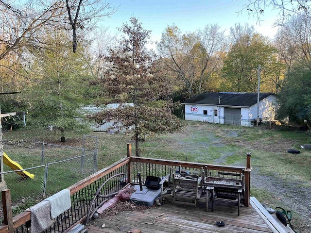 deck featuring an outbuilding and a yard